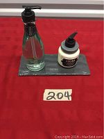 Full set displayed on grey tray on red cloth.