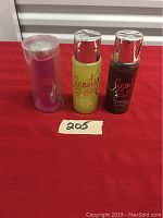 Two images showing three personal care products on a red surface with label '205.'