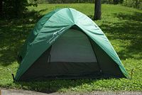 Front view of the green Eureka Swagman 3 tent with open door showing mesh inner door.