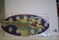 Set of 12 Canadian Millennium quarters from 2000 mounted on chipboard with map design