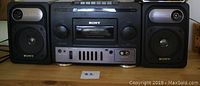Front view of the Sony boom box with cassette player center and detachable left and right speakers on each side.