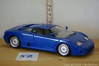 Side view of blue 1:18 scale Bugatti EB110 model car by Bburago with closed doors, no box visible.