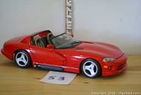 Side view of red 1:18 scale Dodge Viper RT/10 model car showing profile and wheels.