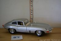 Side profile of silver Jaguar E-Type model showing detailed wire wheels and general condition.