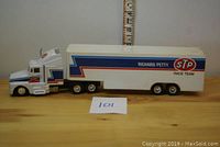Side view of the white Richard Petty Race Team semi-truck model showing STP branding and race stripes.
