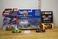 Lot contents showing all cars and decal in package and box form.