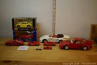 Full display of all 7 Porsche diecast and plastic model cars in various sizes and packaging.