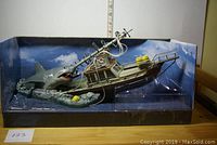 Full view of the Jaws diorama in display box showing shark and boat scene including water and sky background.