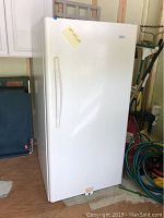 Full view of the white upright Haier freezer with recess handle, showing its size and condition.