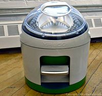 Front view of Yirego non-electric washing machine showing compact, round design with transparent top and foot pedal.