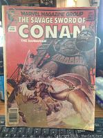 Front cover image of The Savage Sword of Conan comic book showing Conan fighting a giant armored figure, with a red background and date September 1980.