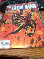 Iron Man comic book cover with Iron Man flying on fiery background