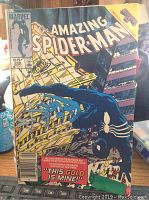 The Amazing Spider-Man #268 comic book cover photo showing Spider-Man in black suit with yellow and purple background.