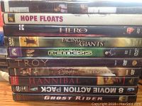 Stack of 9 DVD movies including Hope Floats, I Hero, Facing Giants, Nemesis, Troy, Conan The Complete Quest, Hannibal, an 8 Movie Action Pack, and Ghost Rider.