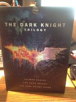 The Dark Knight Trilogy box set front cover with logo and titles.