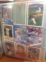 Photo showing a page of several 1993 baseball cards including players in batting and pitching poses.