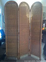 Full frontal view of the 3-panel vintage wicker room divider showing woven cane material within a natural rattan frame.