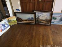 Overview photo showing all five framed paintings on the floor, varying scenes including still life and landscapes