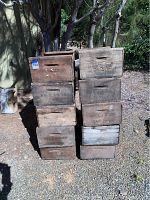 Photo shows 10 stacked vintage wooden fruit crates outdoors, arranged in two stacks of five, with visible 'MRS. E.J. HORN SAN JOSE' stamps and weathered appearance.