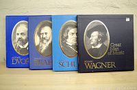 Four boxed sets standing upright with composer portraits on front.