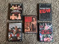 Front covers of five wrestling DVDs including Hardcore Homecoming, The Rise & Fall of ECW, Road Warriors, Hard Knocks (Chris Benoit), and Ultimate Warrior.