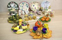 Full overview of 9 spring and fall themed miniature tea sets displayed on a table showing plates, teapots, cups, and decorative trays with seasonal motifs.