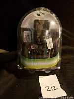 Front view of Bluetooth car FM transmitter in original sealed blister pack with product visible.