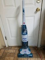 Full view of upright Hoover Floor Mate vacuum cleaner with handle and tank visible