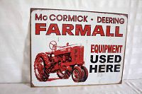 Front view of the Farmall tractor tin sign showing the red tractor illustration and text.