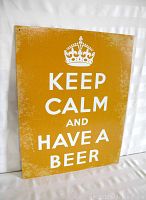 Full front view of the tin sign showing the text and crown with a distressed finish.