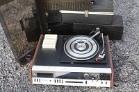 Photo of Webcor Garrard unit with 8-track tapes and cases, unit open showing turntable and controls