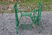 Photo of green cast iron Singer sewing machine base showing overall structure and design.