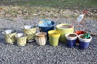 Full lot showing all plant pots and garden accessories on gravel surface outdoors.
