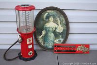 Red Atlas gas pump model with glass cylinder and hose, showing full shape and details