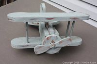 Front angled view showing propeller, top and bottom wings, and distressed paint finish