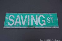 Front view of Saving St street sign showing wear and paint chipping.