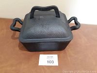 Photo of the covered Dutch oven showing the textured hammered lid and handles.