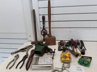 Photo of various old hand tools including vice, mallet, hand drill, screwdrivers, pliers, hammer, file, and hardware items.