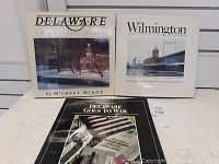 Two Delaware photography books by Michael Biggs, one titled 'Delaware: A Photographic Journey' and the other 'Wilmington'