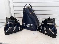 Both Henke ski boots and Molitor carrying case shown together on white surface.