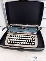 Front view of Smith Corona Classic 12 typewriter open in case showing keyboard and carriage.