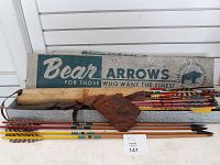Full lot showing two quivers, multiple arrows with various painted shafts and feather fletching, arrows mostly wooden shafts and some with metal tips.