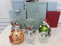 Photo showing all Partylite Christmas items including 2 snow globes, 4 hanging bulbs, and boxes in background.