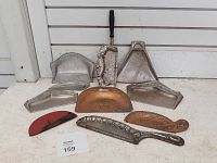 Full lot of eight vintage crumb pans and catchers, showing wear and a variety of shapes and handles.