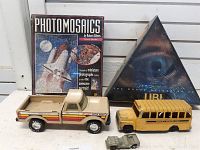Overview of entire lot including Photomosaics puzzle, Ubi board game, Nylint Cattle Ranch truck, and Hubley bus toy.