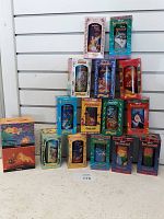 Photo of all 16 collector cups and mugs in their original boxes arranged on a floor surface with slat wall background.
