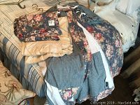 Photo showing the floral bedding set, beige fabric, and checkered fabric components on a bed.