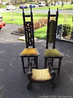 Two high back carved wooden chairs with velvet seats and a small carved wooden stool with velvet seat.