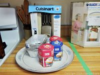 Cuisinart knife set in original box behind panel plates and bake cups