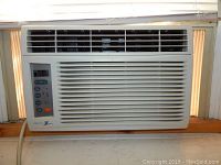 Front view of Zenith ZW6500R white window air conditioner installed in a window